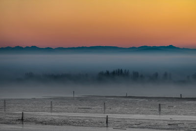 Scenic view of landscape against sky during sunset