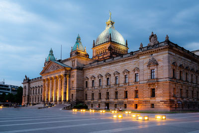Facade of building against cloudy sky