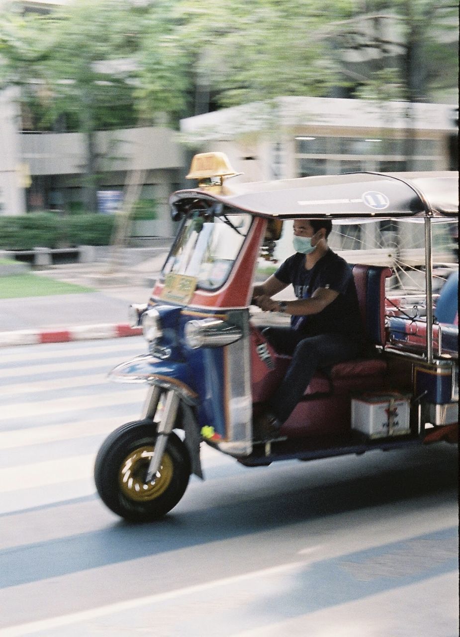 BLURRED IMAGE OF MAN SITTING ON ROAD