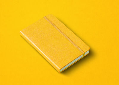 High angle view of pencil on yellow paper