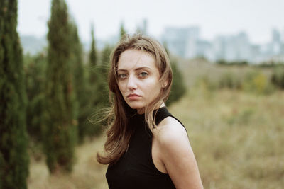 Portrait of beautiful woman standing on land