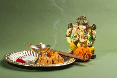 Close-up of figurine in basket on table