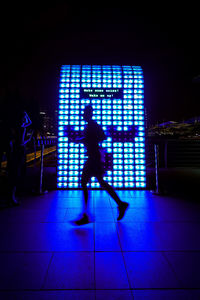 People walking in illuminated city at night