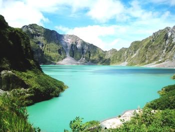 Scenic view of lake against cloudy sky