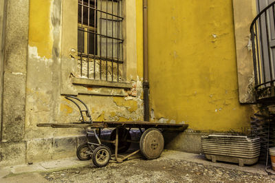 Abandoned building against yellow wall