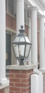 Close-up of lantern on table against building