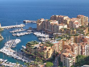 High angle view of buildings by sea against sky - city by the bay residential area