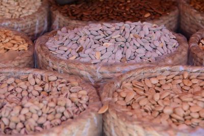 Full frame shot of various nuts in wicker container at market