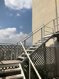 Low angle view of staircase against sky on sunny day