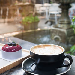 Close-up of coffee in cup on table at outdoor cafe