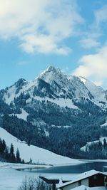 Scenic view of snow covered mountains against sky