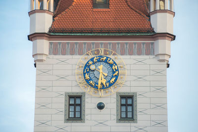 Low angle view of clock tower against building in city