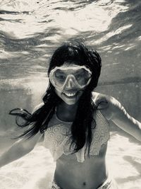 Portrait of girl smiling while snorkeling in sea