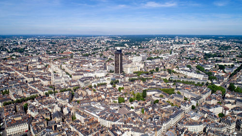 High angle view of city buildings against sky