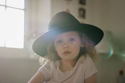 Portrait of a young girl in fancy dress in her room at sunset