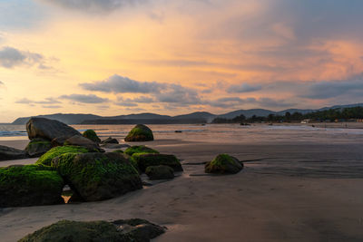 Scenic view of beach against sky during sunset