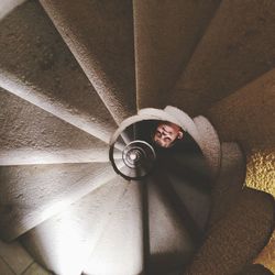 Low angle view of child on spiral staircase