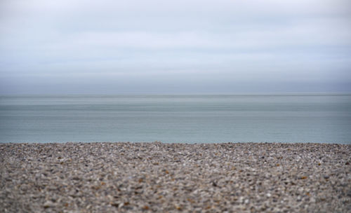 Surface level of sandy beach against sky