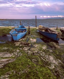 Boat moored on sea against sky