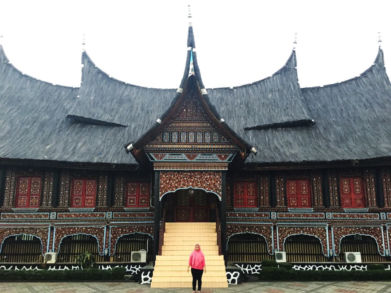 REAR VIEW OF A WOMAN WALKING ON THE BUILDING