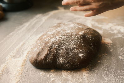 Cropped hands of person preparing food on table