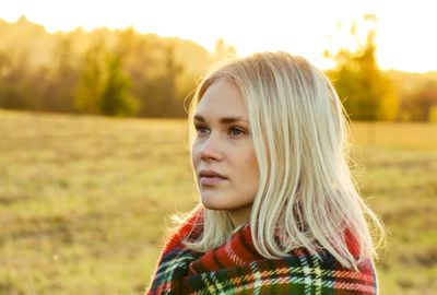 Portrait of young woman in field