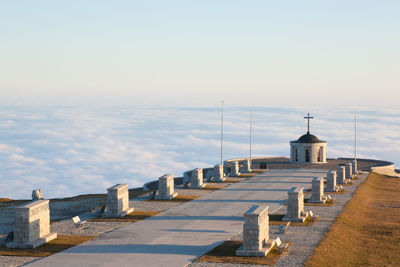 Built structure by sea against sky