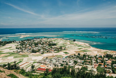 High angle view of sea and buildings against sky