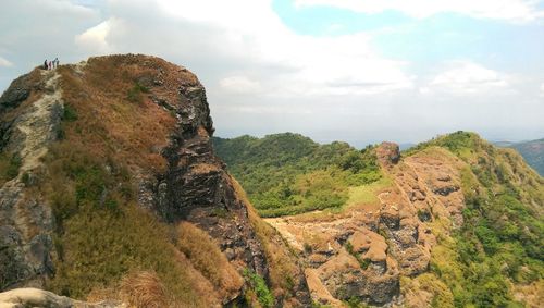 Scenic view of mountains against cloudy sky