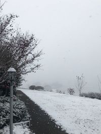 Snow covered field against sky