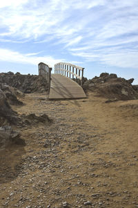 Scenic view of rocks on landscape against sky