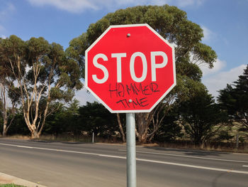 Stop sign  on the road with the graffiti "hammer time"