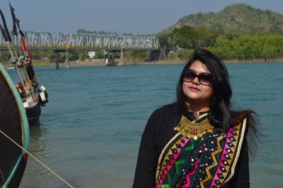 Portrait of woman wearing sari standing against sea