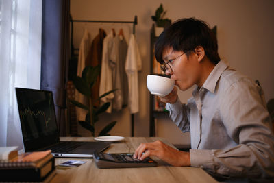 Side view of man working at office