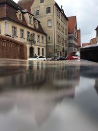 Reflection of buildings on canal in city