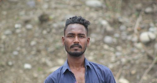 Portrait of young man standing outdoors