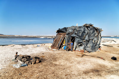 Panoramic view of people on beach against clear sky