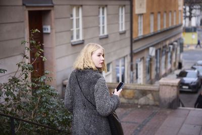 Woman using her cell phone while walking