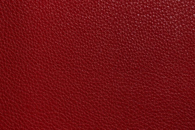 Luxury red leather sample close-up. can be used as background