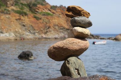 Close-up of rocks on beach against sky