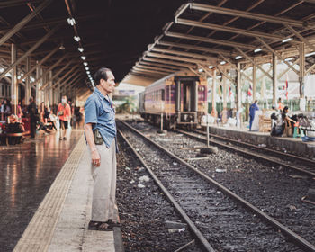 Full length of man at railroad station