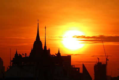 Silhouette temple against sky during sunset