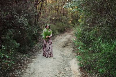 Full length of a man walking in forest