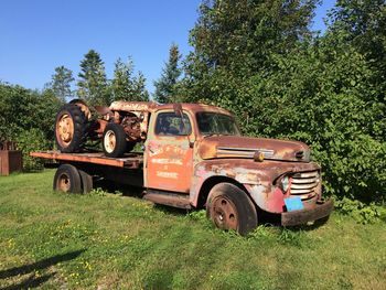 Abandoned vintage car on field