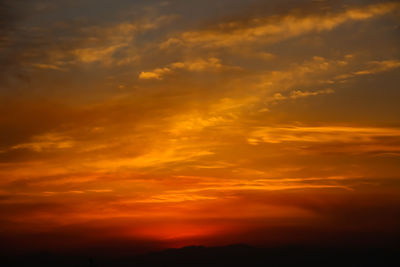 Low angle view of dramatic sky during sunset