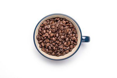 High angle view of coffee beans against white background