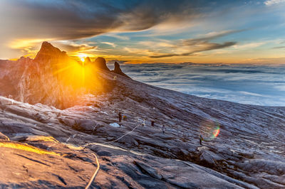 Scenic view of snow covered land against sky during sunset