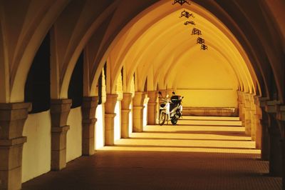 Rear view of man walking in corridor