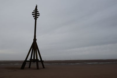 Lifeguard hut on beach against sky