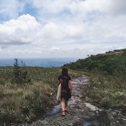 Full length of woman standing on land against sky